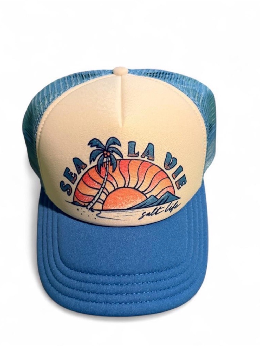 Blue and white Sea La Vie Salt Life trucker hat with palm tree and sunset